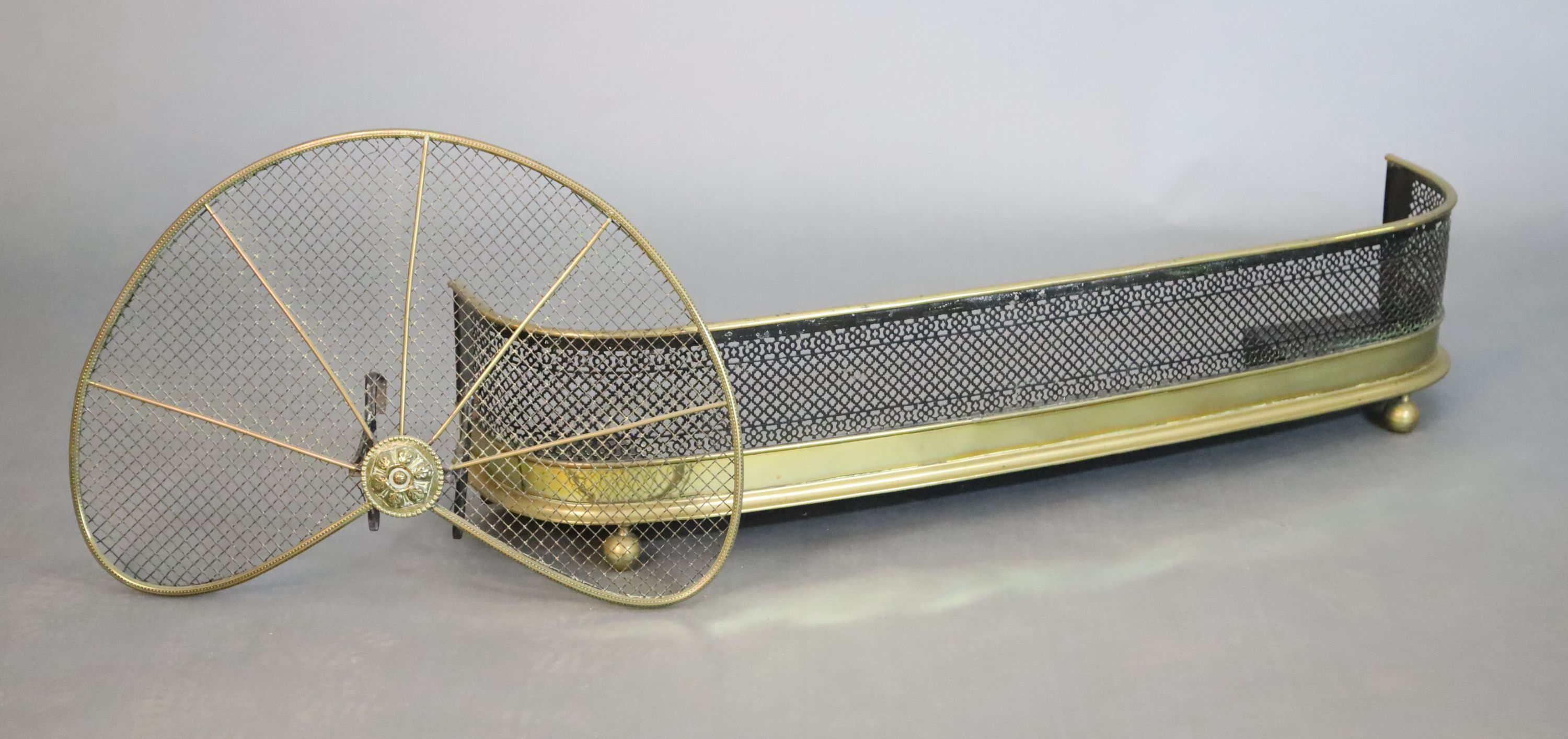 A Regency brass and wire mesh bow fronted kerb and a brass fan shaped spark guard, kerb W.119.5cm D.25.5cm H.27cm guard W.71cm H.46cm